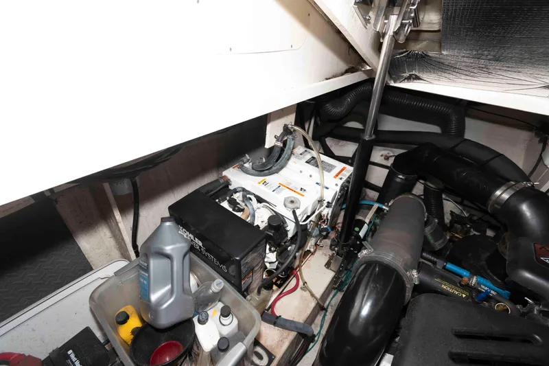 Slide: The Image of Engine room of 2007 Sea Ray 340 Sundancer with mechanical components and maintenance supplies. - 23