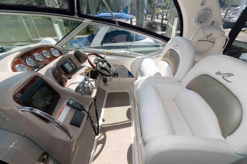Slide: The Image of Interior of 2007 Sea Ray 340 Sundancer yacht with luxurious white seating and control panel. - 6