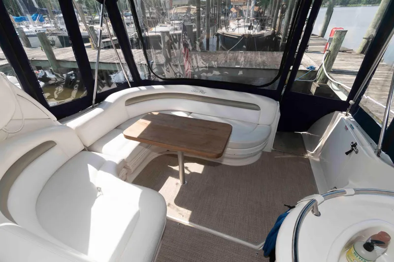 Slide: The Image of Luxurious 2007 Sea Ray 340 Sundancer boat interior with plush seating and wooden table. - 9