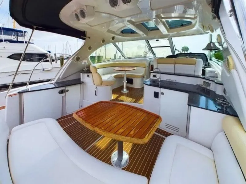 Slide: The Image of Luxurious 2008 Four Winns V458 yacht interior with elegant seating and wooden table. - 10