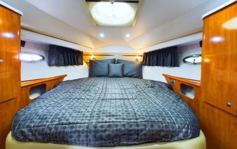 Slide: The Image of Luxurious cabin interior of 2008 Four Winns V458 yacht with elegant bedding and wood finish. - 14