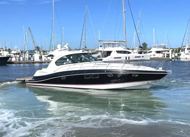 Slide: The Image of 2008 Four Winns V458 yacht cruising in a marina with sailboats in the background. - 3