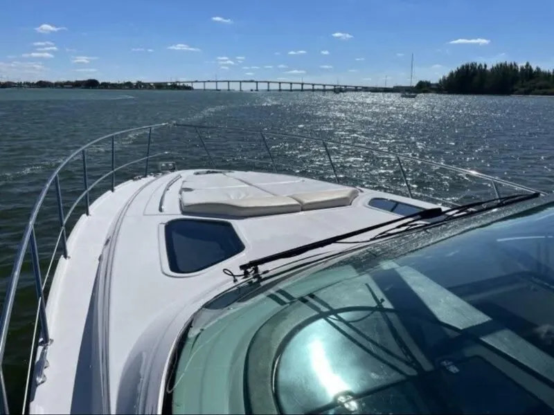 Slide: The Image of 2008 Four Winns V458 yacht cruising on a sunny day with bridge in background. - 5