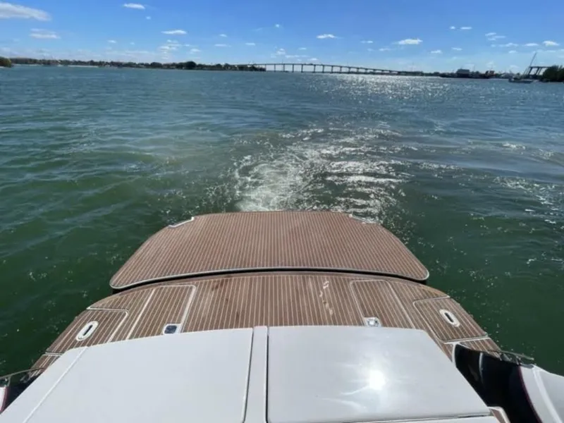 Slide: The Image of 2008 Four Winns V458 boat on water, rear view with wooden deck, sunny day. - 6