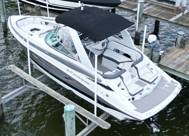 Slide: The Image of 2023 Crownline 270 SS boat docked, featuring sleek design and spacious seating. - 1