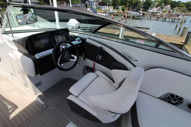 Slide: The Image of 2023 Crownline 270 SS boat interior with modern dashboard and comfortable seating. - 10