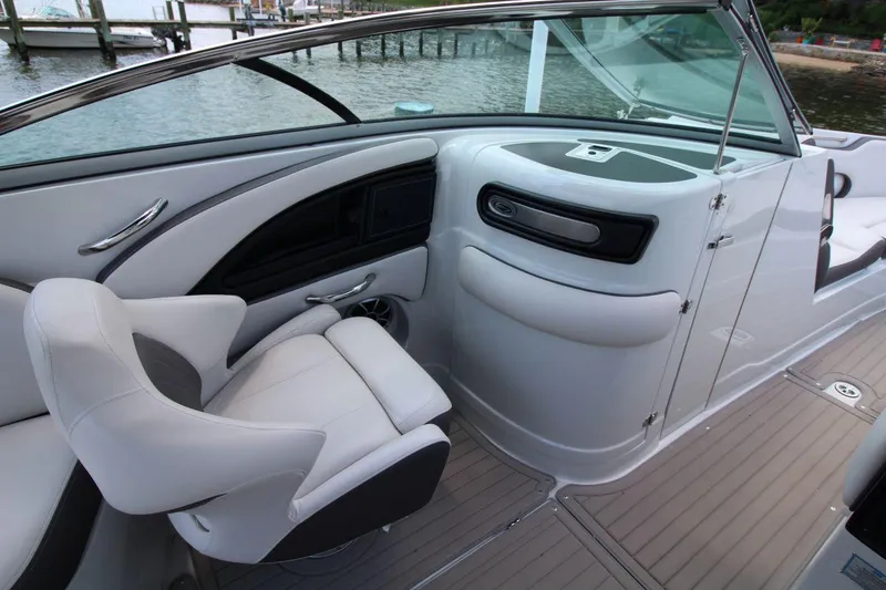 Slide: The Image of 2023 Crownline 270 SS boat interior with sleek seating and modern dashboard design. - 12
