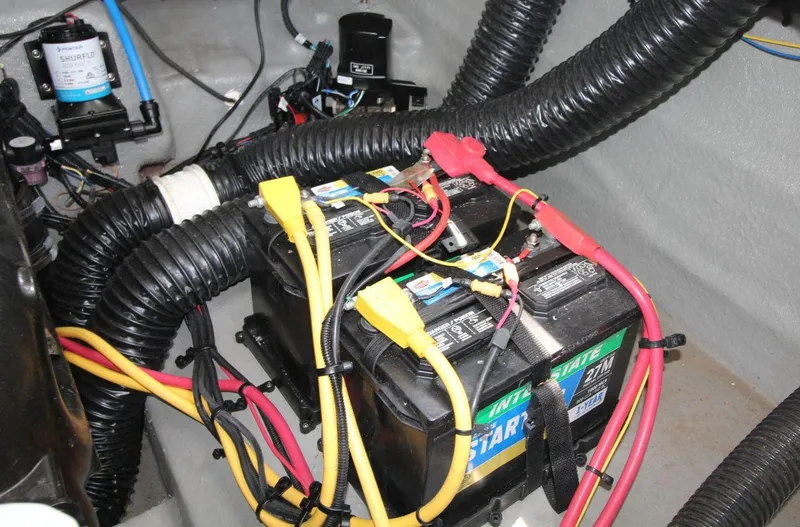 Slide: The Image of Battery setup in 2023 Crownline 270 SS boat, featuring wiring and components. - 21