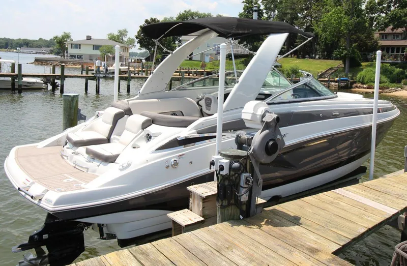 Slide: The Image of 2023 Crownline 270 SS boat docked at a marina, featuring sleek design and spacious seating. - 4