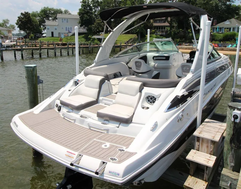 Slide: The Image of 2023 Crownline 270 SS boat docked, featuring sleek design and comfortable seating. - 5