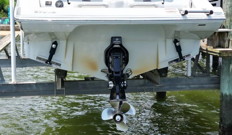 Slide: The Image of 2023 Crownline 270 SS boat on lift, showing stern and propeller. - 7