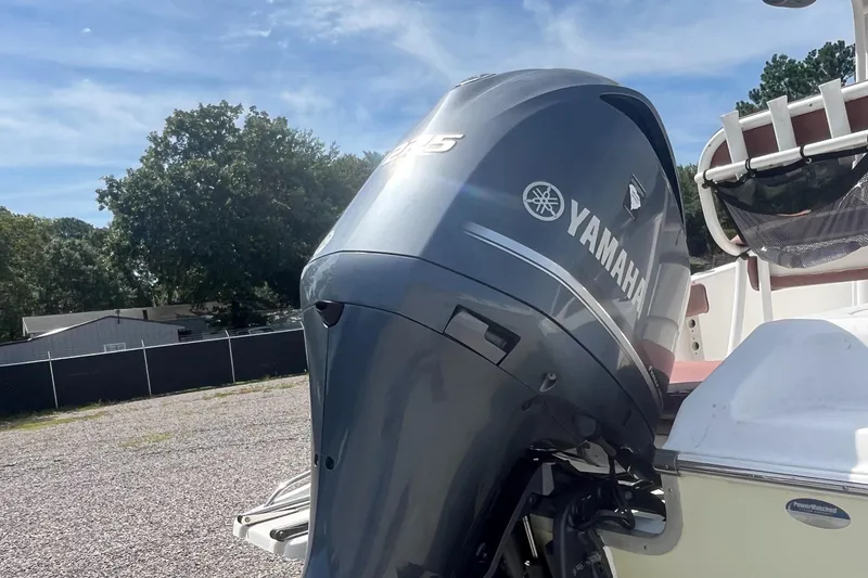 Slide: The Image of Yamaha outboard motor on a 2010 Tidewater 216 CC Adventure boat, parked outdoors. - 10