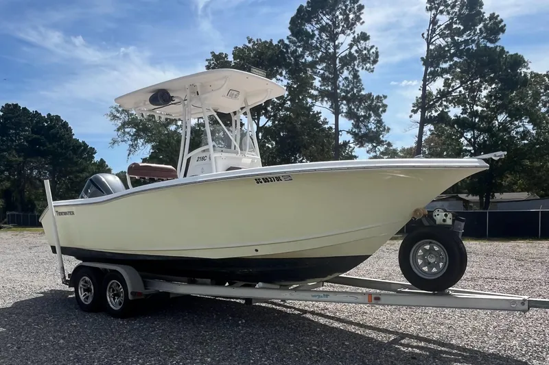 Slide: The Image of 2010 Tidewater 216 CC Adventure boat on trailer, parked outdoors. - 3