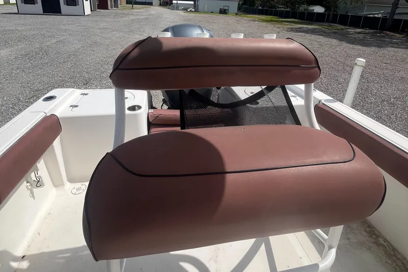 Slide: The Image of 2010 Tidewater 216 CC Adventure boat interior with brown cushioned seating. - 5