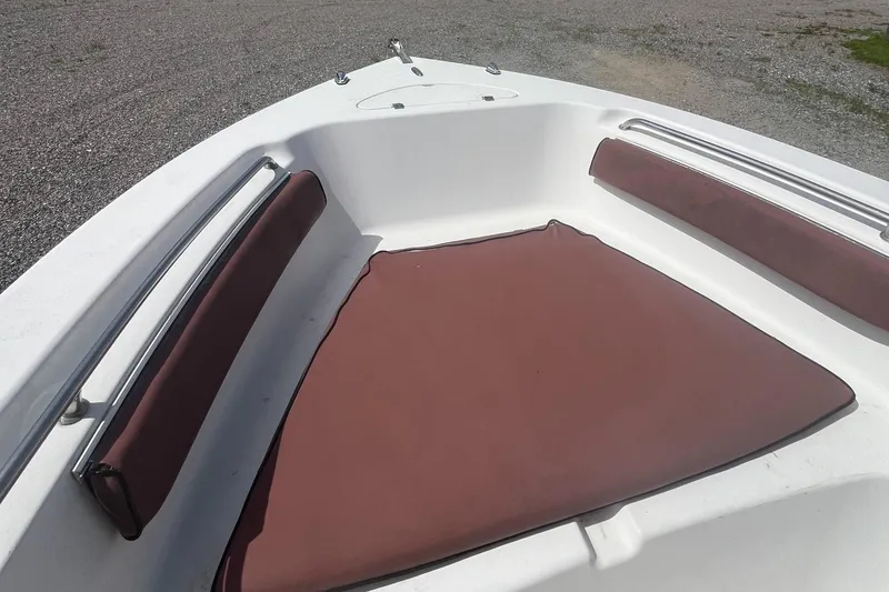 Slide: The Image of Bow seating area of 2010 Tidewater 216 CC Adventure boat with brown cushions. - 6