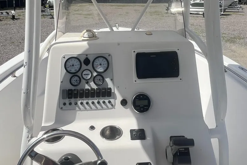 Slide: The Image of 2010 Tidewater 216 CC Adventure boat dashboard with gauges and controls. - 8