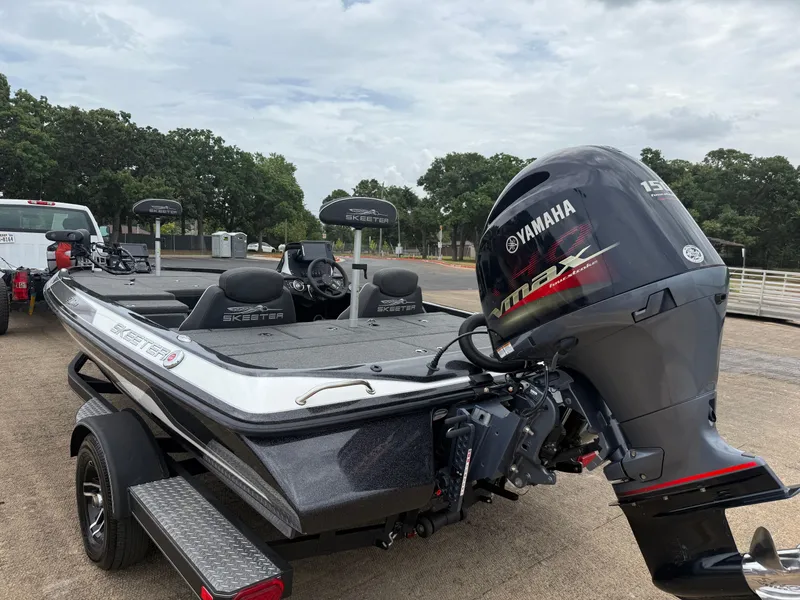 Slide: The Image of 2022 Skeeter ZX 150 boat with Yamaha VMAX engine, parked outdoors. - 12