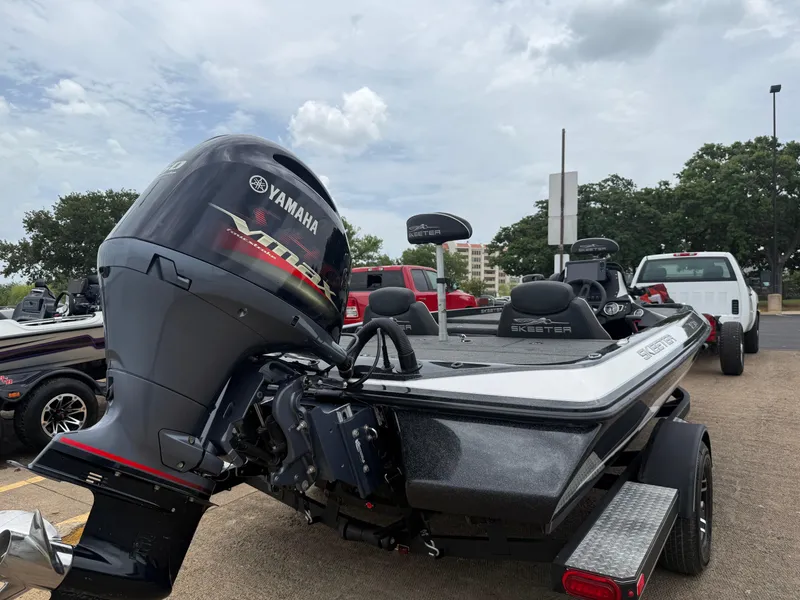 Slide: The Image of 2022 Skeeter ZX 150 boat with Yamaha engine, parked outdoors on a cloudy day. - 15