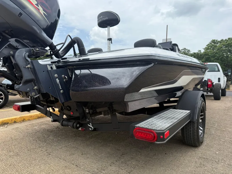 Slide: The Image of 2022 Skeeter ZX 150 boat on trailer, rear view, parked outdoors. - 16