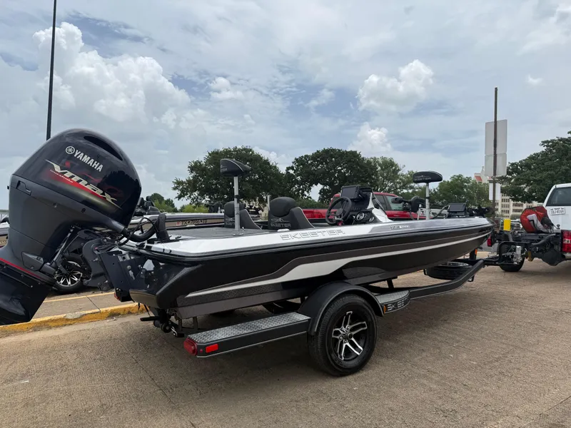 Slide: The Image of 2022 Skeeter ZX 150 boat with Yamaha engine on a trailer, parked outdoors. - 17