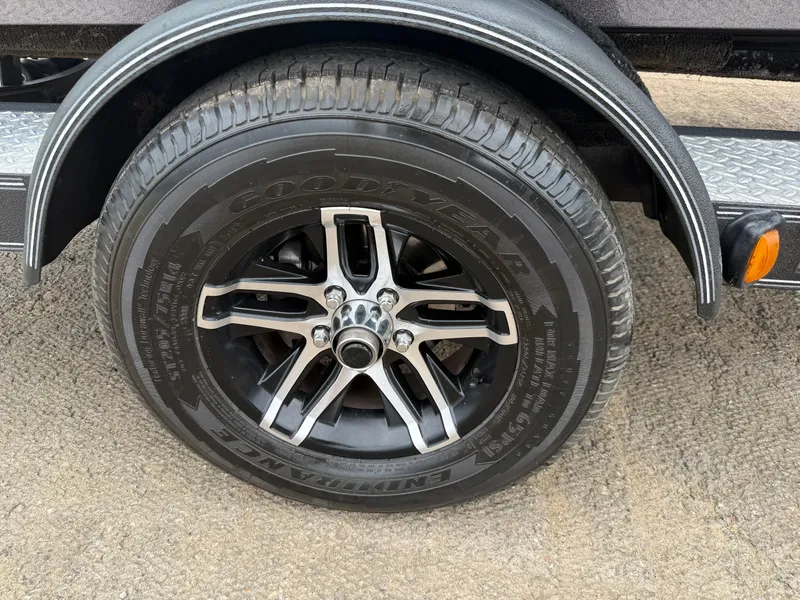 Slide: The Image of 2022 Skeeter ZX 150 trailer tire with Goodyear branding and alloy wheel. - 19