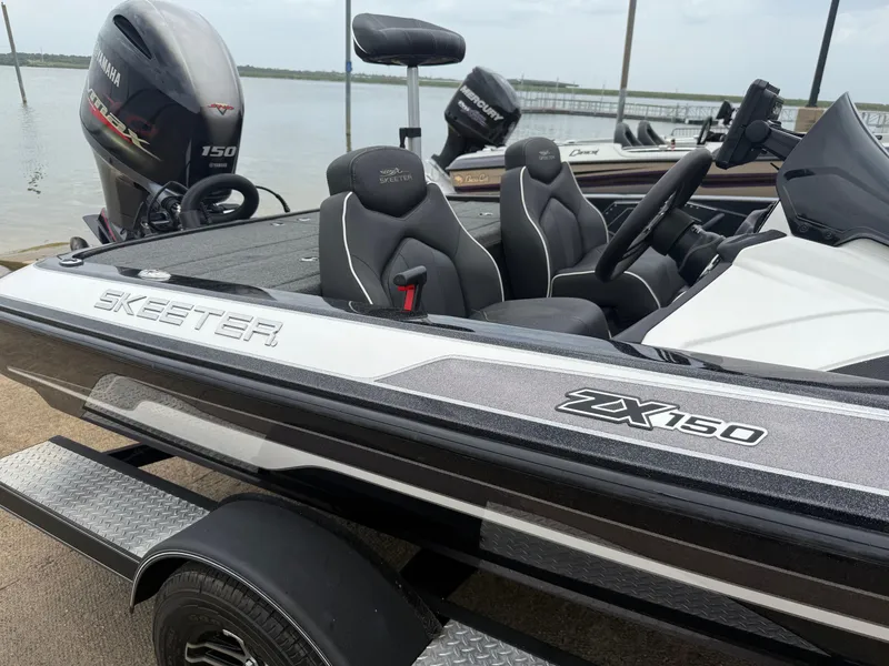 Slide: The Image of 2022 Skeeter ZX 150 boat with Yamaha engine, docked by the water. - 21