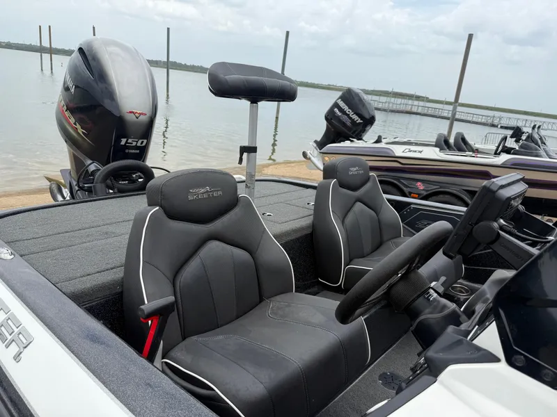 Slide: The Image of 2022 Skeeter ZX 150 boat with Yamaha engine, docked by a lake. - 22