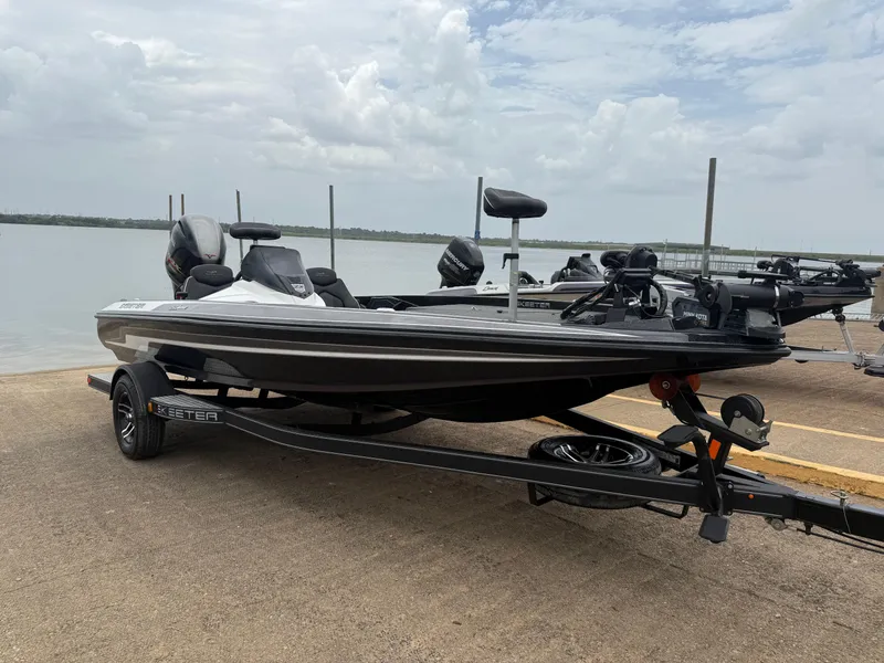 Slide: The Image of 2022 Skeeter ZX 150 boat on trailer by a lake under cloudy sky. - 24