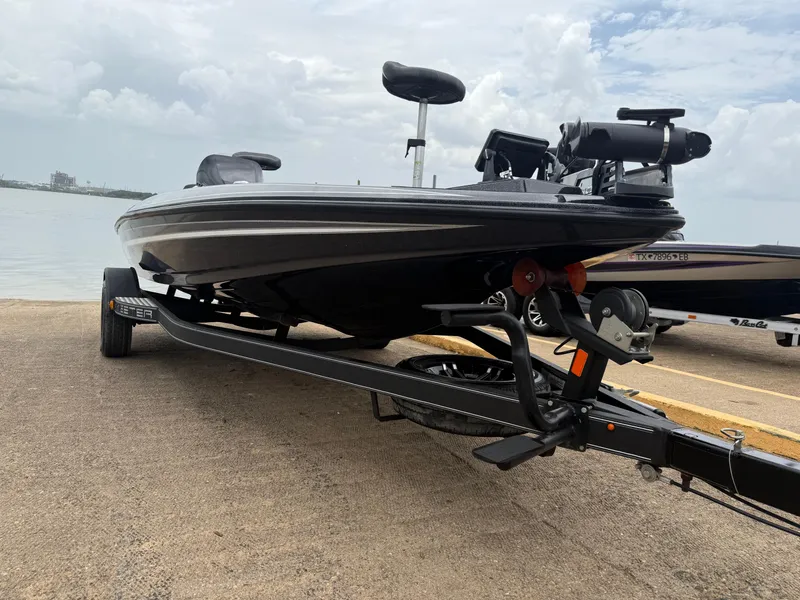 Slide: The Image of 2022 Skeeter ZX 150 boat on trailer by waterfront, under cloudy sky. - 25