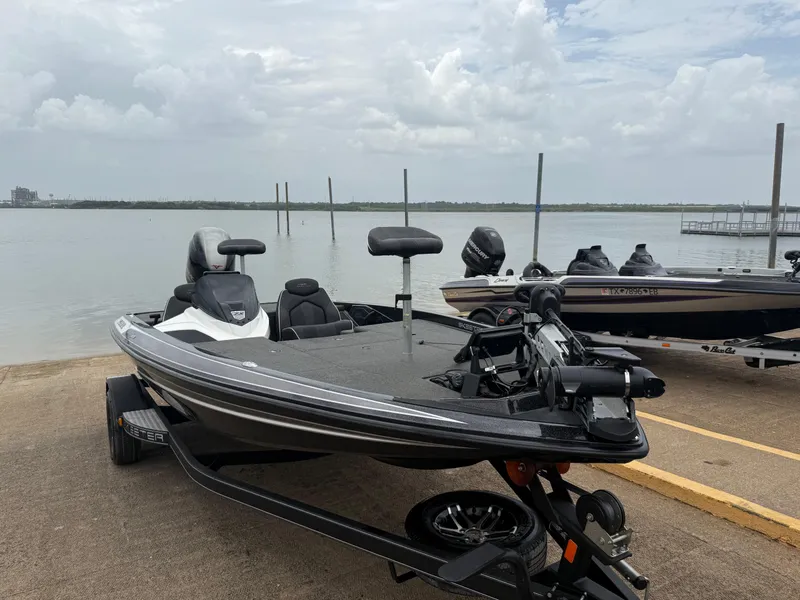 Slide: The Image of 2022 Skeeter ZX 150 boat on trailer by a lake under cloudy skies. - 26