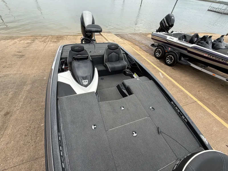 Slide: The Image of 2022 Skeeter ZX 150 boat on a ramp, near water, with another boat nearby. - 29