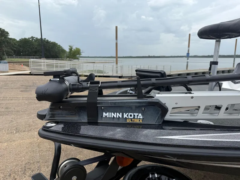 Slide: The Image of 2022 Skeeter ZX 150 boat with Minn Kota Ultrex trolling motor at a lakeside dock. - 3