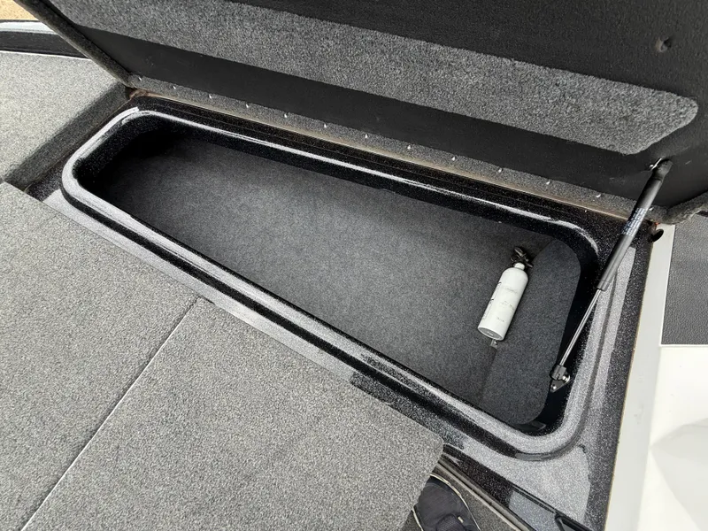 Slide: The Image of Open storage compartment in 2022 Skeeter ZX 150 boat with fire extinguisher. - 35