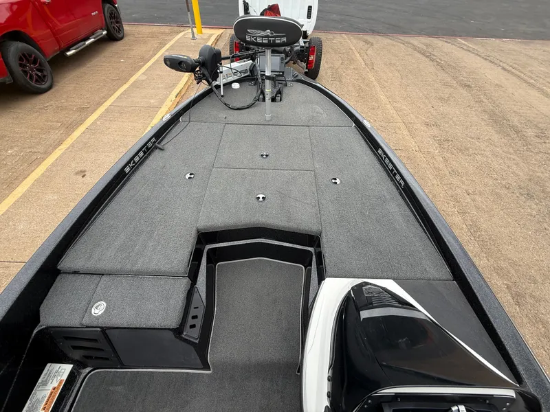Slide: The Image of 2022 Skeeter ZX 150 boat deck with trolling motor and storage compartments. - 37