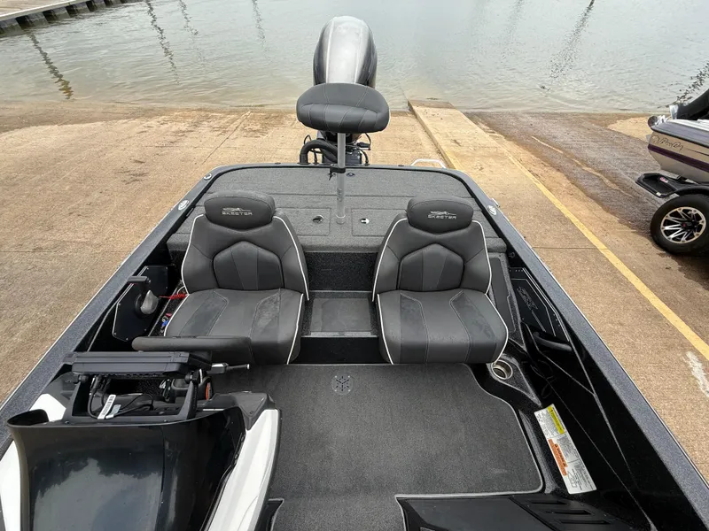 Slide: The Image of 2022 Skeeter ZX 150 boat interior with dual seats, steering console, and water in background. - 39