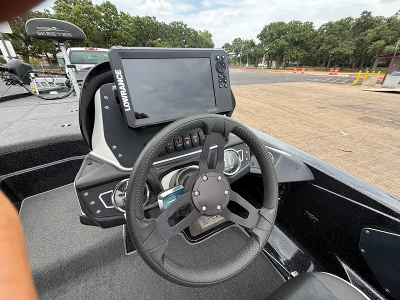 Slide: The Image of 2022 Skeeter ZX 150 boat dashboard with Lowrance display and steering wheel. - 42
