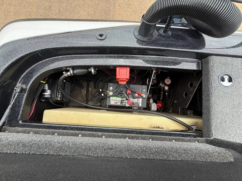 Slide: The Image of 2022 Skeeter ZX 150 boat battery compartment with wiring and components. - 48