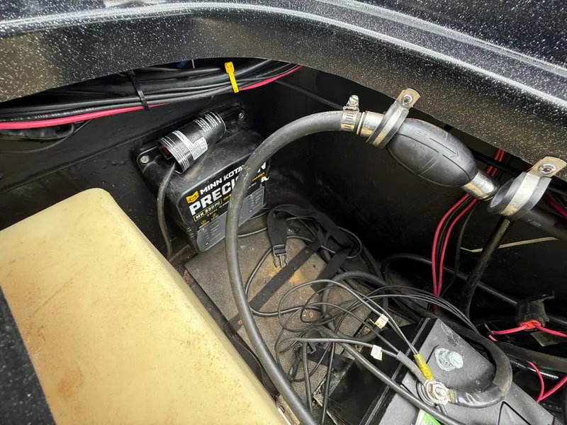 Slide: The Image of 2022 Skeeter ZX 150 boat battery compartment with Minn Kota Precision charger and wiring. - 49