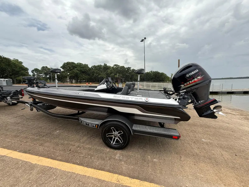 Slide: The Image of 2022 Skeeter ZX 150 boat with Yamaha engine on trailer by a lake. - 6