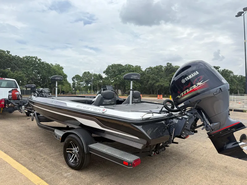Slide: The Image of 2022 Skeeter ZX 150 boat with Yamaha engine on trailer, parked outdoors. - 7