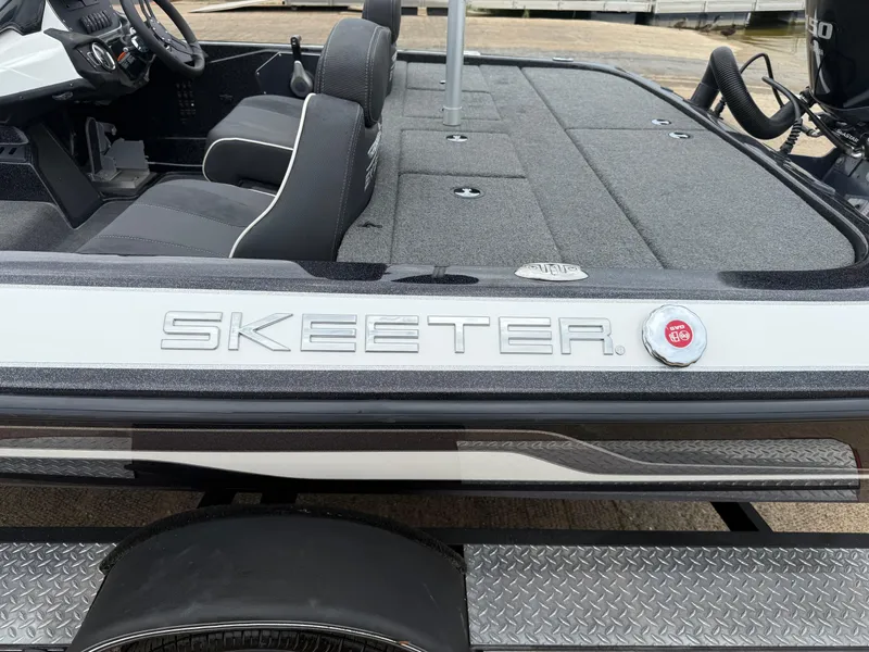 Slide: The Image of 2022 Skeeter ZX 150 boat interior with steering wheel and seating. - 8