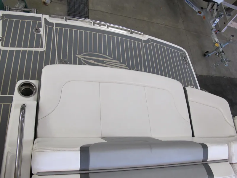 Slide: The Image of 2018 Chaparral 287 SSX boat deck with cushioned seating and cup holder. - 10
