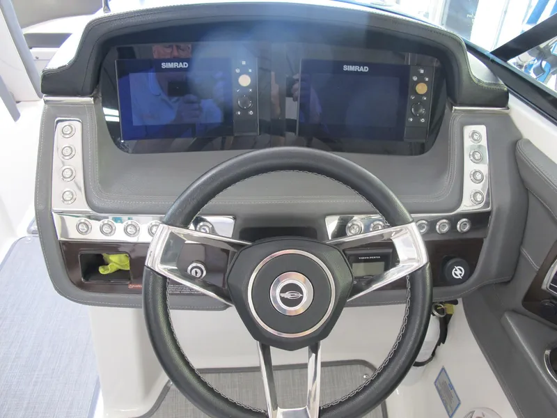 Slide: The Image of 2018 Chaparral 287 SSX dashboard with dual Simrad displays and steering wheel. - 11