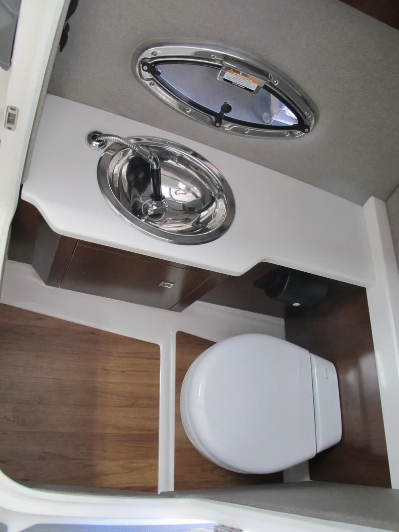 Slide: The Image of 2018 Chaparral 287 SSX boat bathroom with sink and toilet. - 13
