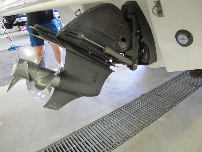 Slide: The Image of 2018 Chaparral 287 SSX boat propeller and stern drive in a garage setting. - 14