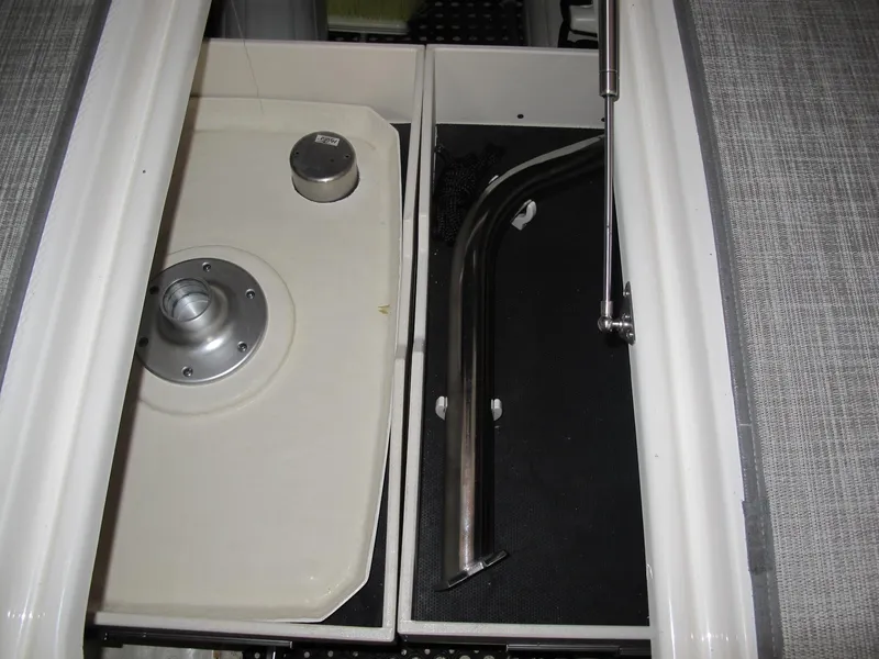 Slide: The Image of 2018 Chaparral 287 SSX boat storage compartment with metal fittings and hydraulic support. - 18