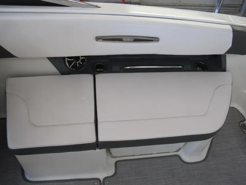 Slide: The Image of 2018 Chaparral 287 SSX boat interior seating with cup holders and speaker. - 8