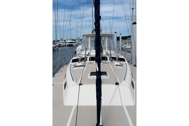 Slide: The Image of 2004 Island Packet 485 sailboat docked at marina, showcasing deck and mast. - 11