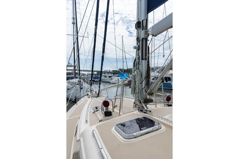 Slide: The Image of 2004 Island Packet 485 sailboat deck view with marina background. - 12