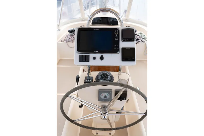 Slide: The Image of Helm of 2004 Island Packet 485 sailboat with navigation equipment and steering wheel. - 13